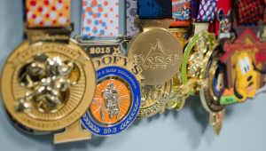 Image of Dr. Scott's many Disney marathon medals